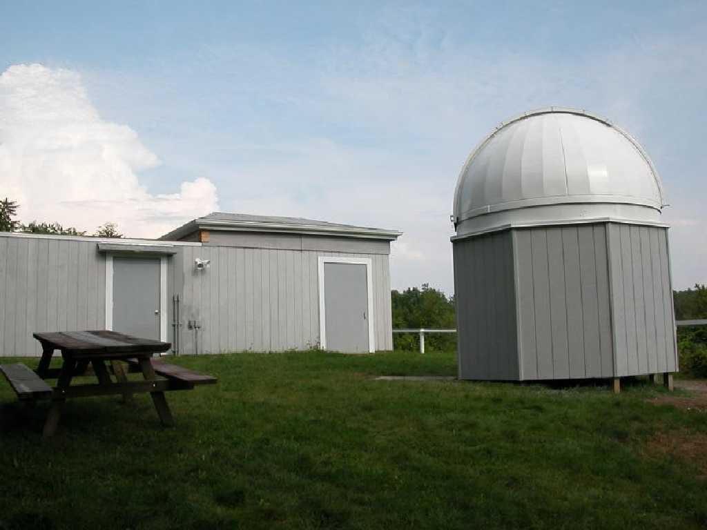 Indian Hill Observatory — dome and outbuildings under a summer sky